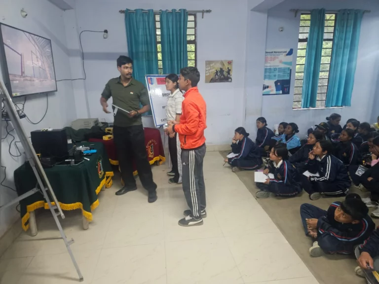 Instructor explaining drone operations to cadets beside a presentation screen at Gangtok