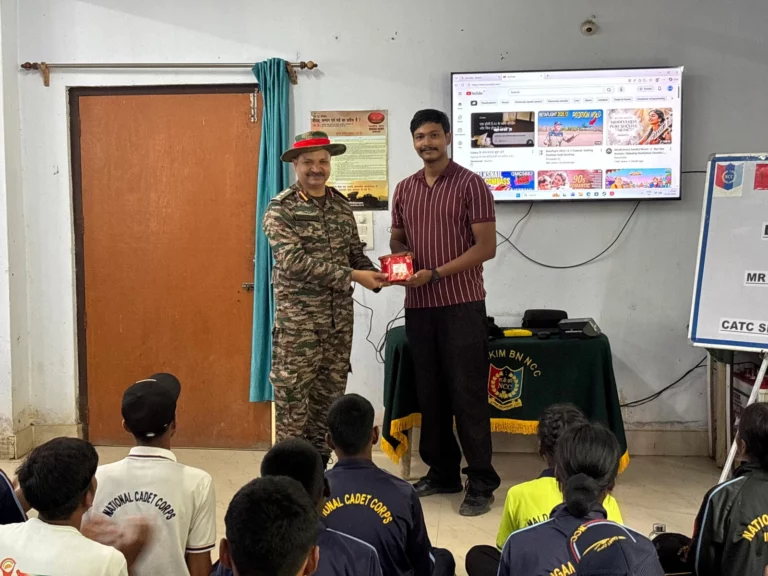 Army officer and Trinetra trainer exchanging a memento beside the display at the Gangtok NCC unit