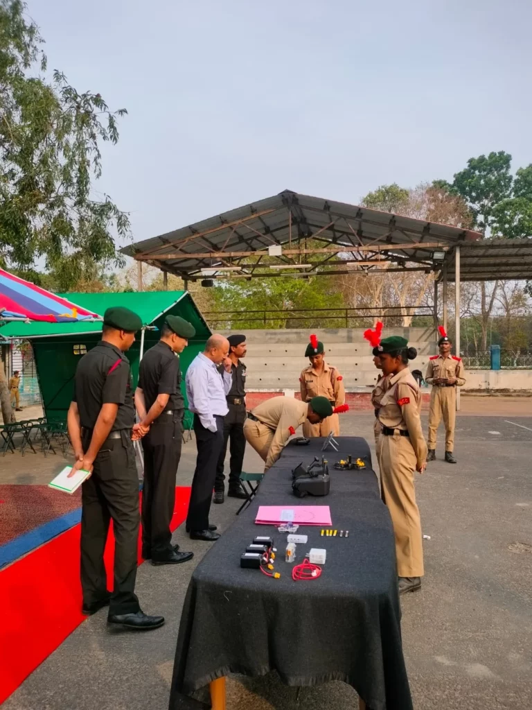 Drone equipment displayed on a table with cadets and an officer at Kalyani