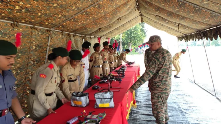 Cadets and an army officer examining drones on the display table