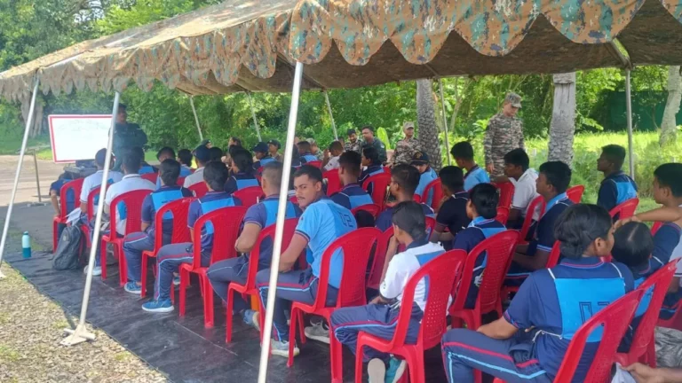 NCC cadets seated for a drone session under camouflage netting