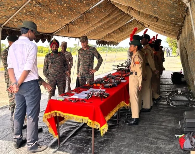 Cadets and officers at the drone display table under the tent